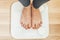 Barefoot female legs stand on electronic scales