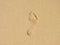 Barefoot footstep on the sand