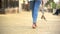 Barefoot girl walking down street holding in hands high-heeled sandals, freedom