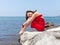 Barefoot girl on wild rocky seashore