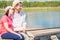 Barefoot happy couple on the pier to catch a fish