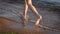 Barefoot kids legs feet running on sand beach ocean shore at sunset. Summer vacation, holiday, family trip. Tourism to