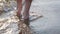 Barefoot kids legs feet walking on beach ocean water. Summer vacation, holiday, family trip. Tourism to warm countries