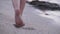 Barefoot legs walking on send at sea beach