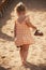 Barefoot little girl walking on beach