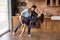 Barefoot millennial spouses dancing partners perform passionate tango at kitchen