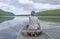 Barefoot Paddler on a Calm Lake