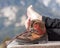 Barefoot person relaxing on a bench in the mountains hiking shoes close-up