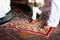 Barefoot pilgrims walking on the floor with painted mandala  in Hindu temple. India