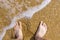 Barefoot on sea surf sand