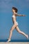Barefoot slim girl in white bikini running