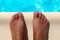 Barefoot on swimming pool background, top view