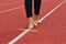 Barefoot on the white line of the red running track