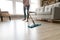 Barefoot woman cleaning floor with wet mop pad cropped image.