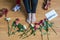 Barefoot woman on the floor with crumpled paper of letter among scattered flowers. Broken relationships in bad Valentine`s day.