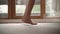 Barefoot woman legs on carpet closeup. Female feet stand on floor and turn to camera. Lady in hotel
