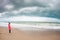 Barefoot woman looks at the winter sea