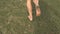 Barefoot woman running through deserted land on cracked dry background.