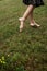 Barefoot woman walking on the grass