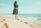 Barefoot woman walking on sand beach.