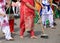 barefoot women Sikh sweep the road during the ceremony along the