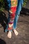Barefoot young woman in boho style embroidered blue jeans lower