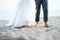 Barefooted bride and groom on the beach