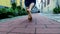 Barefooted chinese contemporary dancer in red shirt and black hat.