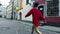 Barefooted chinese contemporary dancer in red shirt and black hat.