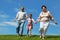 Barefooted little girl and grandparents running