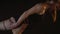 A barefooted man supports a woman on acrobatics, a shibari shooting close-up