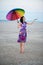 Barefooted woman with colorful umbrella