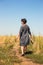 Barefooted woman on path through field