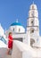 Barefooted woman in red dress enjoying the sun at Santorini island