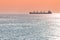 Barge at beautiful sunset. Anchorage for ships, copy space. Amazing evening seascape, breathtaking travel view