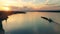 A barge and a coast of a river port at sunset