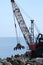 Barge with crane for dredging the seabed at the port of Riomaggiore, Cinque Terre, royalty free