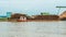Barge full of timber as raw material for wood chip industry