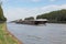 Barge navigating at Dutch canal near Amsterdam