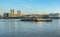 Barge pulling containers on the River Thames at Greenwich.