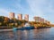 A barge on the river. Modern beautiful new buildings in the autumn. A new residential neighborhood in the north of Moscow