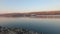 Barge runs on the water along the Danube river separating Hungary and Slovakia. The camera turns slowly.