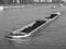 barge transporting earth on river Rhein in Koeln, black and whit
