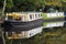 Barges converted into houseboats moored on a canal in hebden bridge