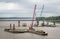 barges with cranes and pile driving equipment at a construction of a bridge over the Mississippi River at Chain of Rocks