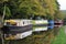 Barges and houseboats moored along the canal near hebden bridge