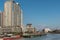 Barges and skyscrapers along Paisg River in Manila Philippines