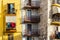 Bari, Italy - March 10, 2019: Older woman leaning on the balcony of her colorful house