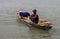 Barisal, Bangladesh - March 12, 2023, A fisherman catching fish on a small dinghy floating on a river. Beautiful Southeast Asian