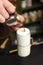 Barista adding coffee to steamed milk at counter